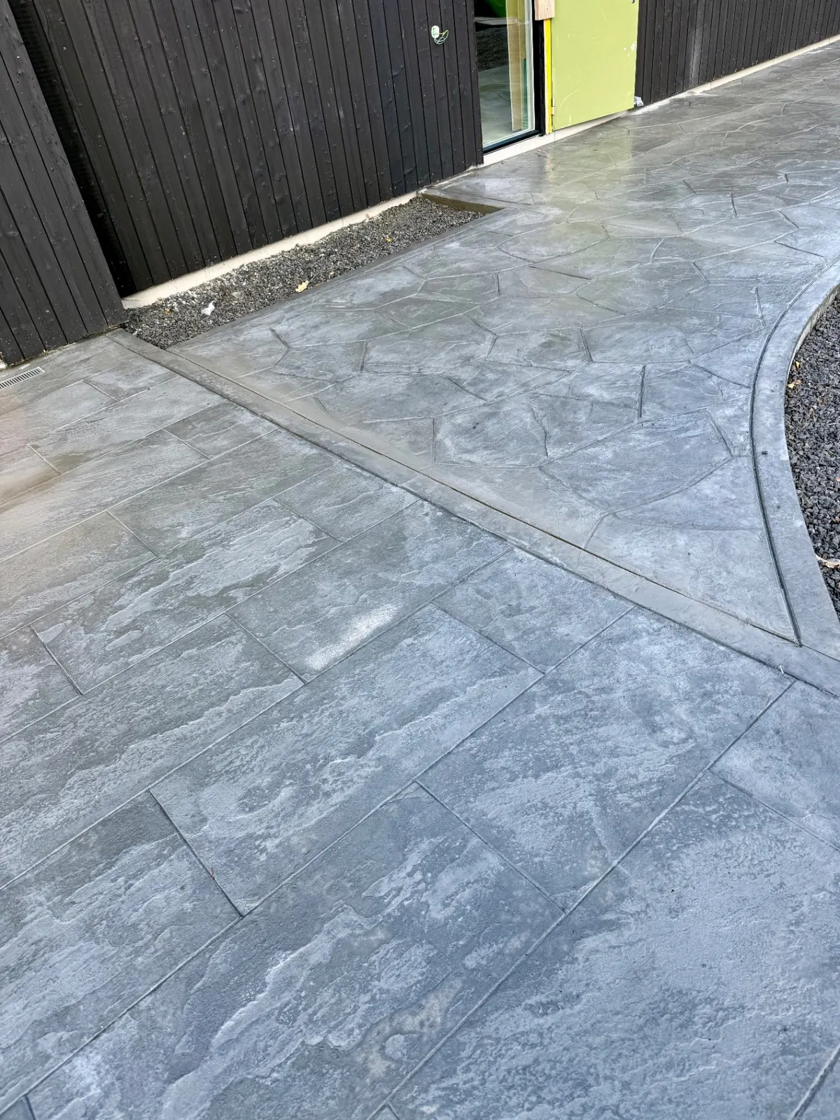 Mönsterbetong med 45x90 bluestone och oregelbunden skiffer avdelade av en board